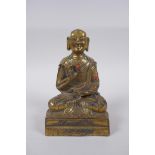 A Sino Tibetan gilt bronze figure of Buddha seated in meditation inset with semi precious stones,