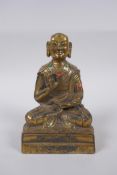 A Sino Tibetan gilt bronze figure of Buddha seated in meditation inset with semi precious stones,