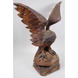 A Black Forest carved wood figure of an eagle with outstretched wings, 52cm high