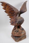 A Black Forest carved wood figure of an eagle with outstretched wings, 52cm high