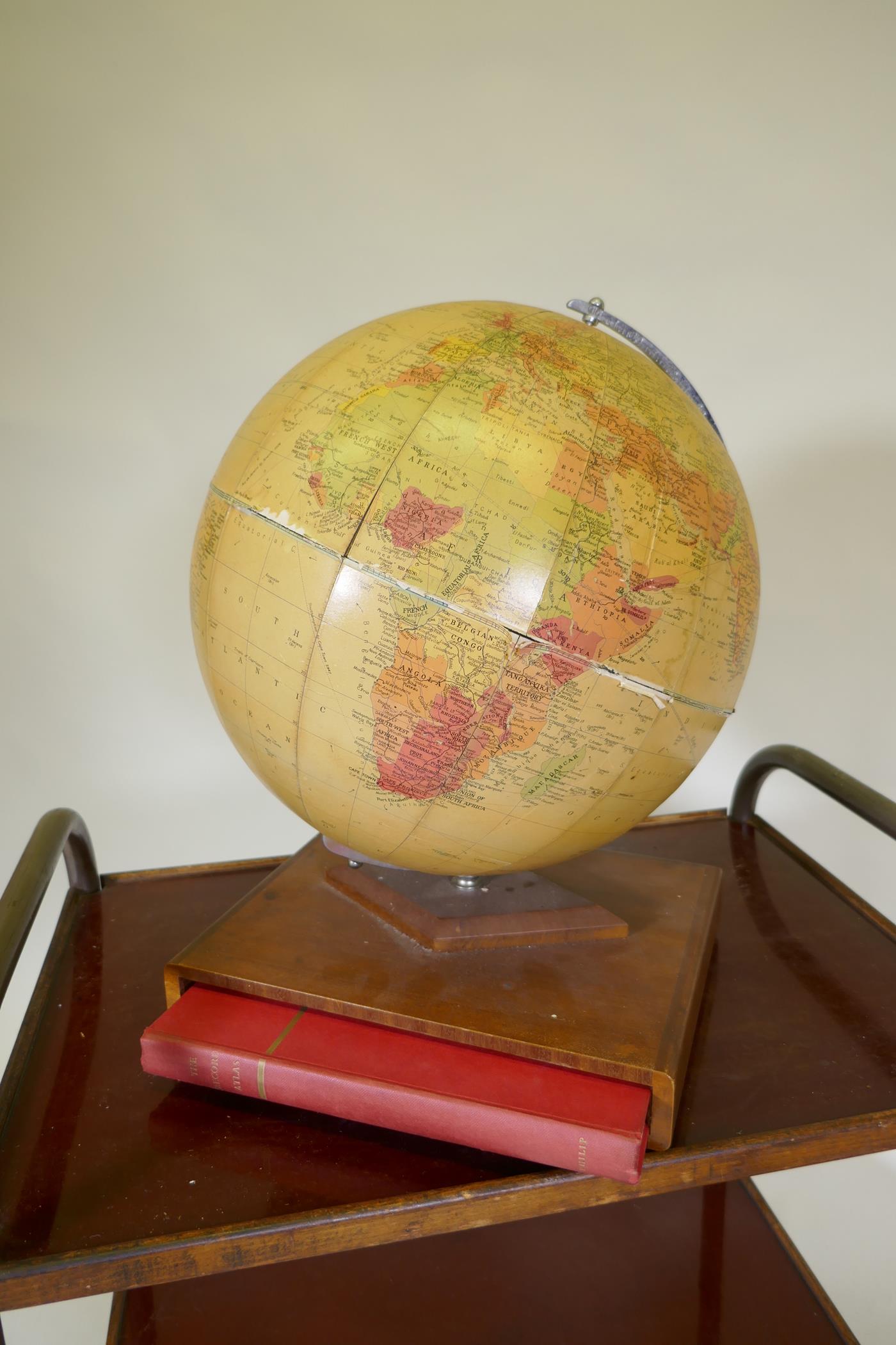 A Philips terrestrial globe with a volume of Philips Record Atlas concealed to the base, a C19th - Image 2 of 9