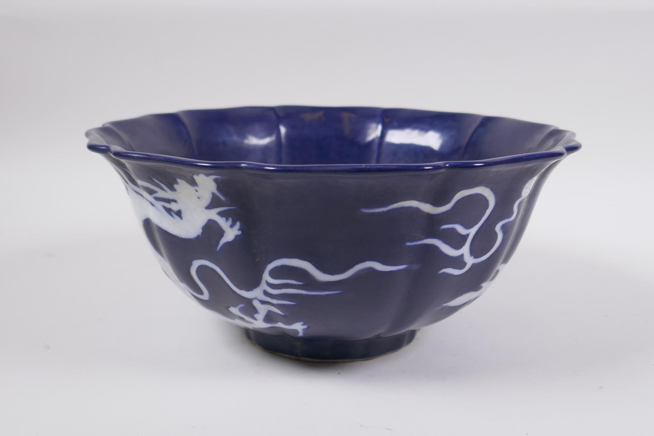 A Chinese blue and white porcelain steep sided bowl with lobed rim, decorated with a white dragon - Image 4 of 6