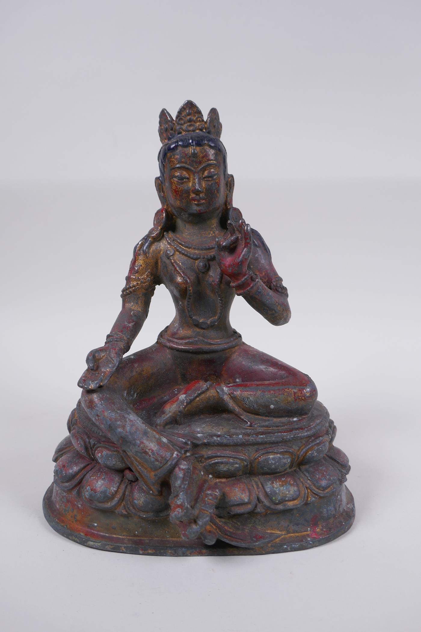 A Sino Tibetan bronze figure of a female deity with the remnants of gilt patina, 20cm high