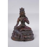 A Sino Tibetan bronze figure of a female deity with the remnants of gilt patina, 20cm high