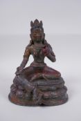 A Sino Tibetan bronze figure of a female deity with the remnants of gilt patina, 20cm high