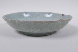 A Chinese celadon glazed porcelain dish with a petal shaped rim, AF, 19cm diameter
