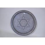 A Middle Eastern brass tray, engraved with Islamic calligraphy and geometric designs, 63cm diameter