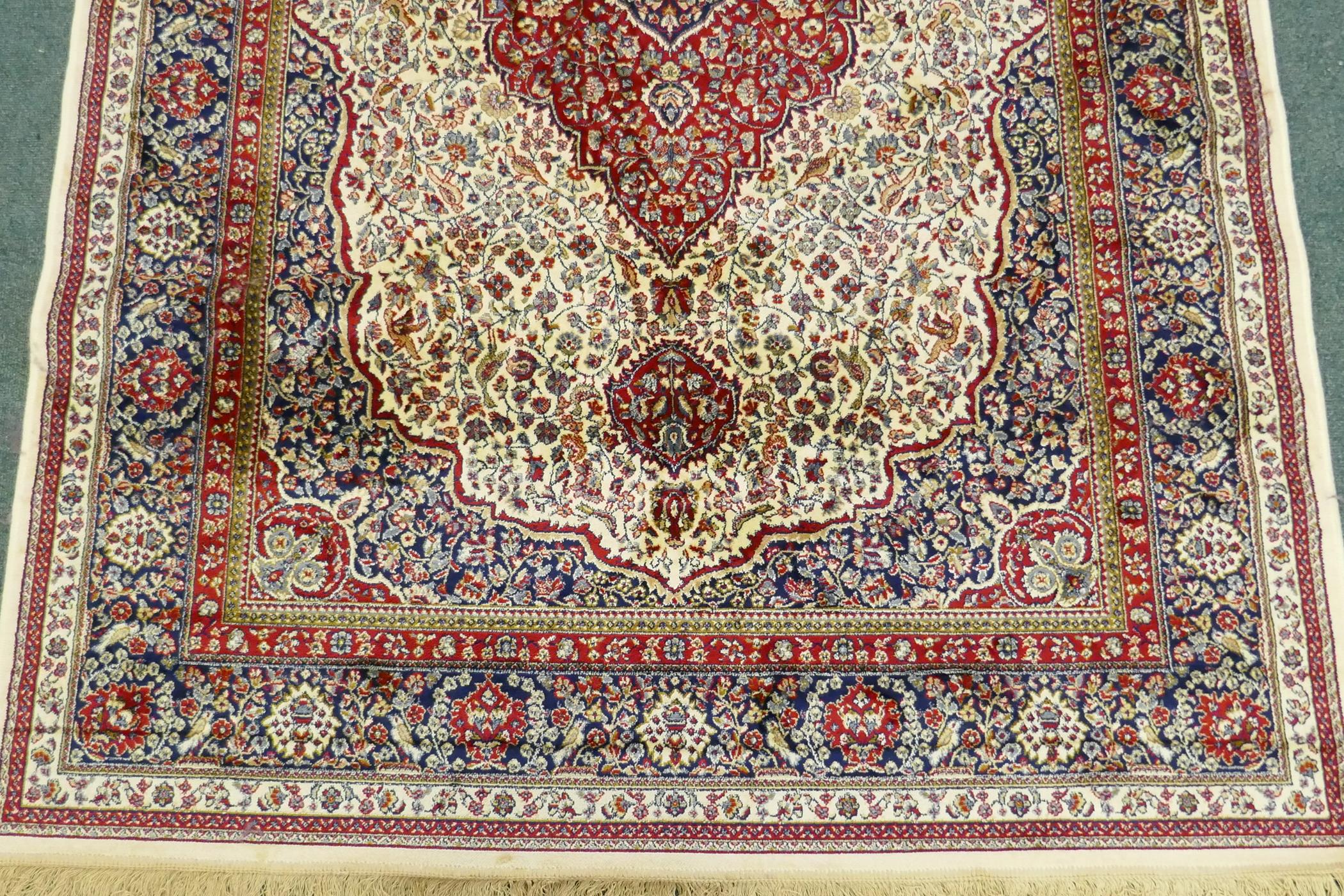 An ivory ground Kashmir carpet with central floral medallion design, 240 x 156cm - Image 5 of 5