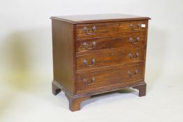 A mahogany chest of small proportions and four long drawers with cock beaded detail, raised on