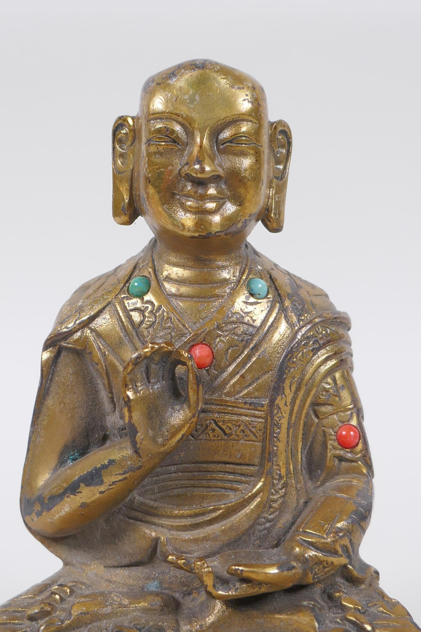 A Sino Tibetan gilt bronze figure of Buddha seated in meditation inset with semi precious stones, - Image 2 of 4