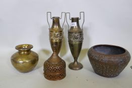 An Indian brass pot with engraved decoration, a copper jardiniere, a pair of brass urns, 33cm high