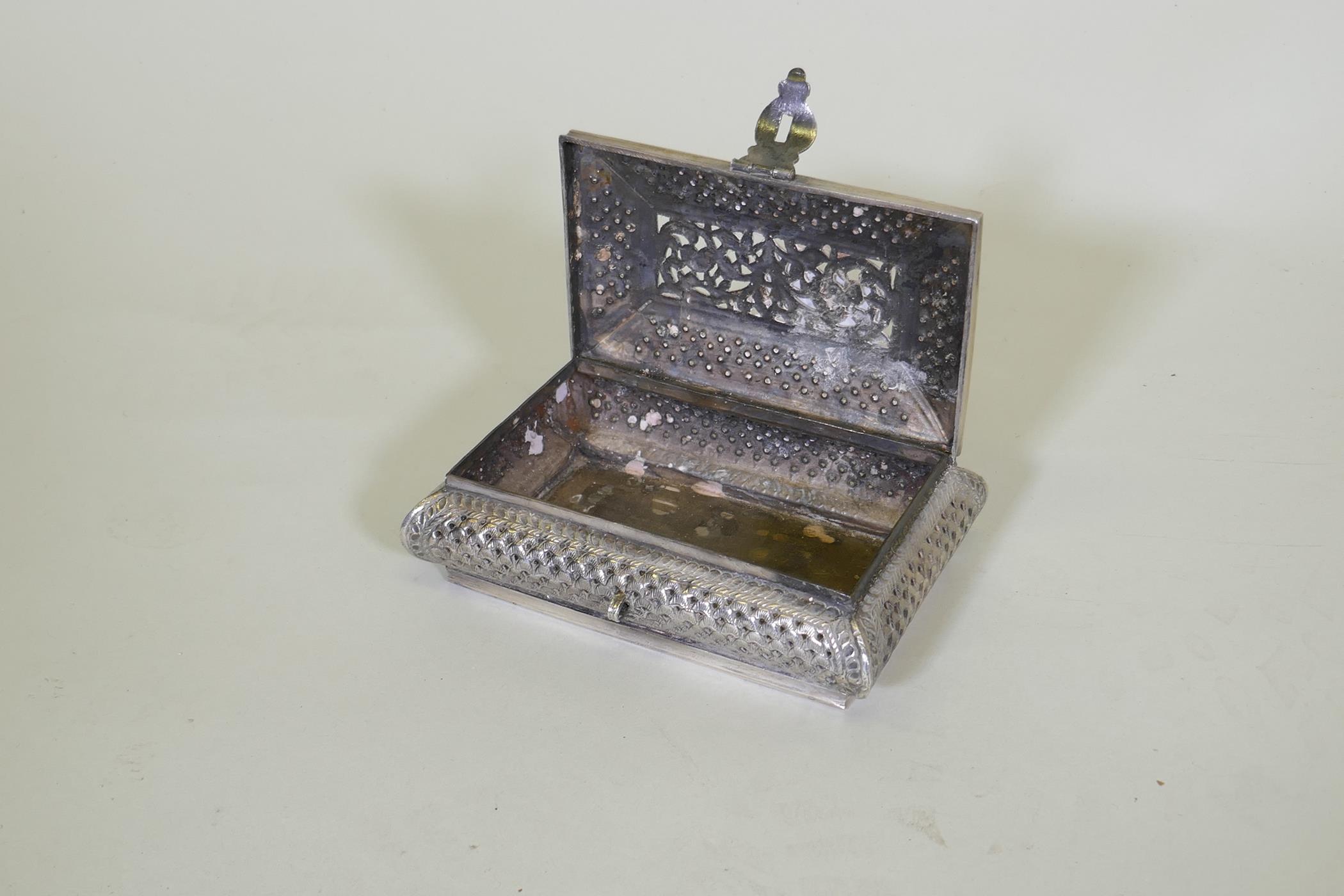 An oriental white metal cushion shaped box with engraved and pierced decoration, marked 'silver' - Image 5 of 5