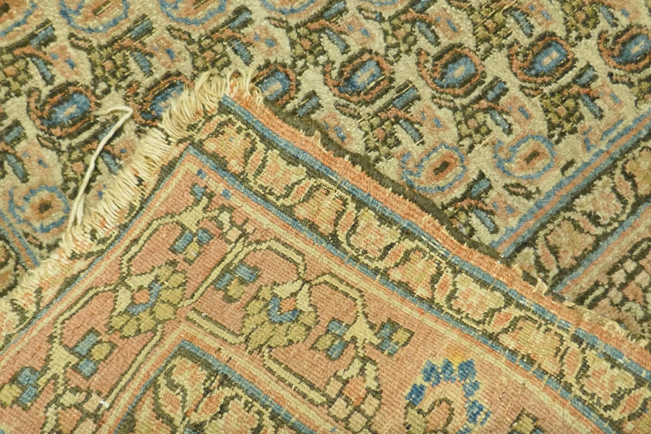 A Middle Eastern hand woven wool carpet with all over geometric designs on a faded terracotta field, - Image 4 of 4