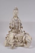 A Chinese blanc de chine porcelain figure of Quan Yin seated on an elephant's back, impressed seal