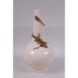 A Chinese peach ground porcelain vase with applied and gilt dragon decoration, 25cm high, seal