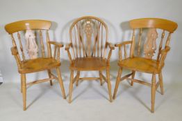 A pair of beech elbow chairs and a beech Windsor armchair