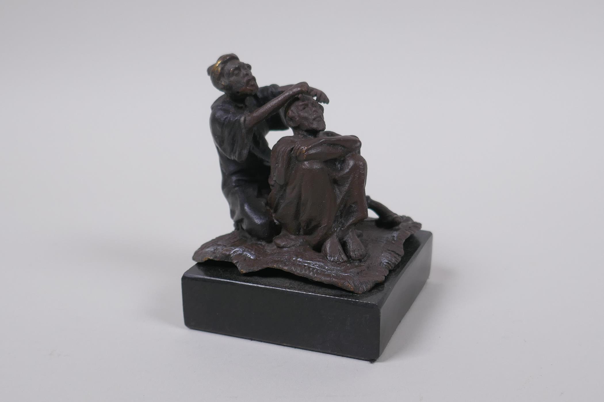 A Bergman style bronze figure of an Arab barber, 8cm high