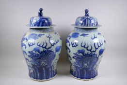 A pair of Chinese blue and white baluster shaped jars and covers with kylin decoration, 51cm high