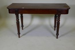 A C19th mahogany D shaped serving table, raised on turned and reeded supports, 135 x 55 x 73cm