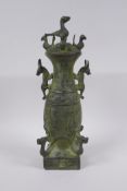 A Chinese archaic style bronze vase and cover with two kylin handles and decoration with mythical
