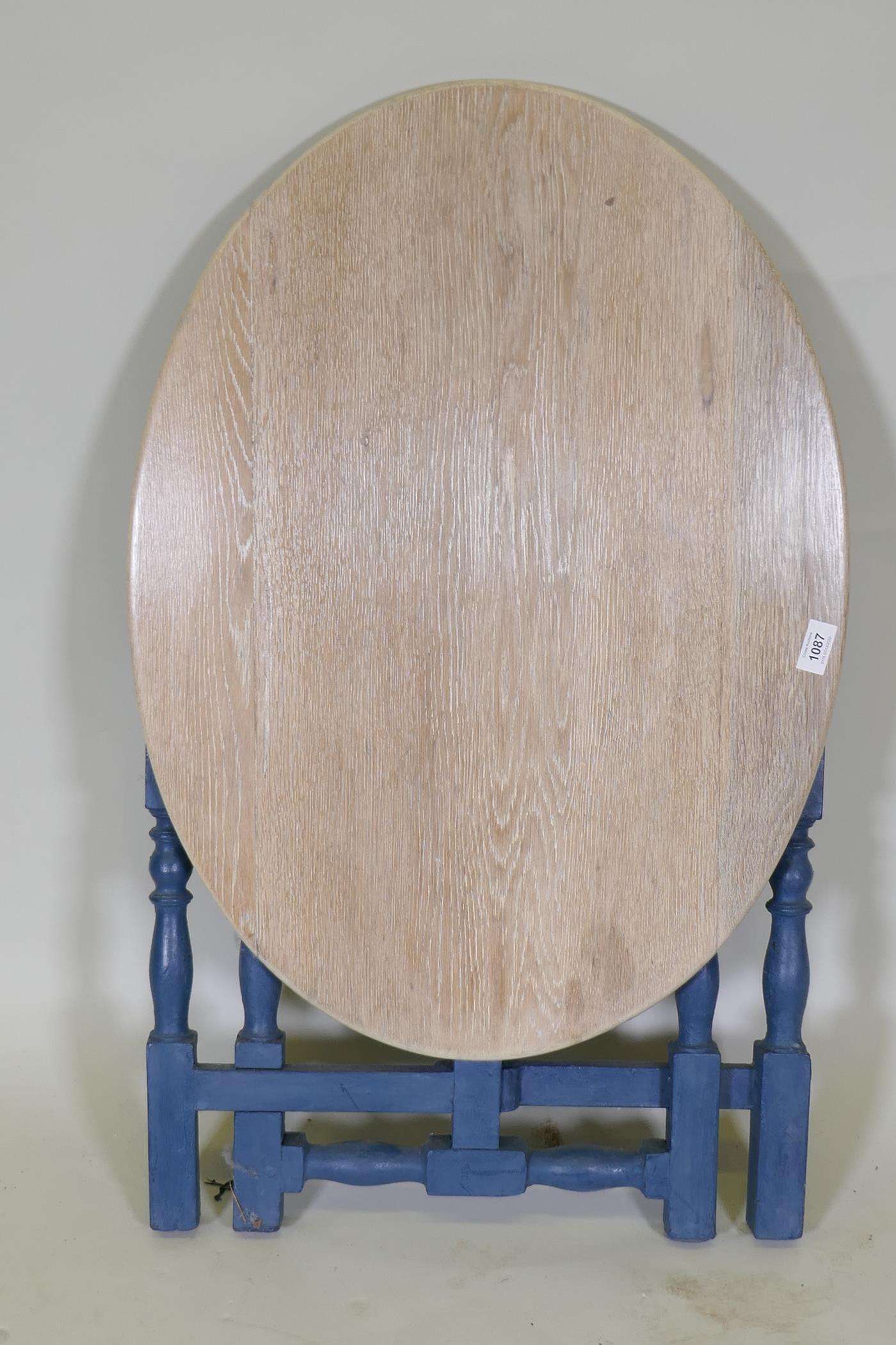 A painted oak folding table with oval limed top, 74 x 55cm, 56cm high - Image 4 of 5