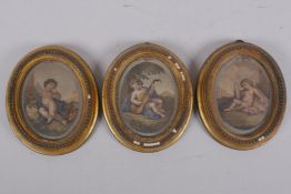 Three C19th oval framed hand coloured engravings of putti, aperture 8 x 10.5cm