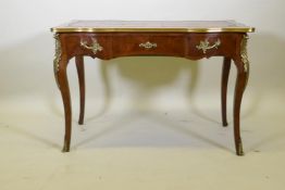 A C19th rosewood writing table, with ormolu mounts, the serpentine shaped top with blind tooled