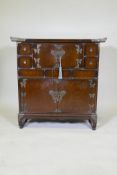 An oriental cabinet with elm veneered front and brass mounts, four drawers flanking two cupboards