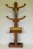 A Victorian oak hallstand with inset mirror and pierced decoration, 192cm high x 80cm