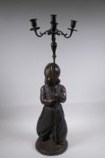 A bronze four branch candlestick in the form of an Arab child, 77cm high