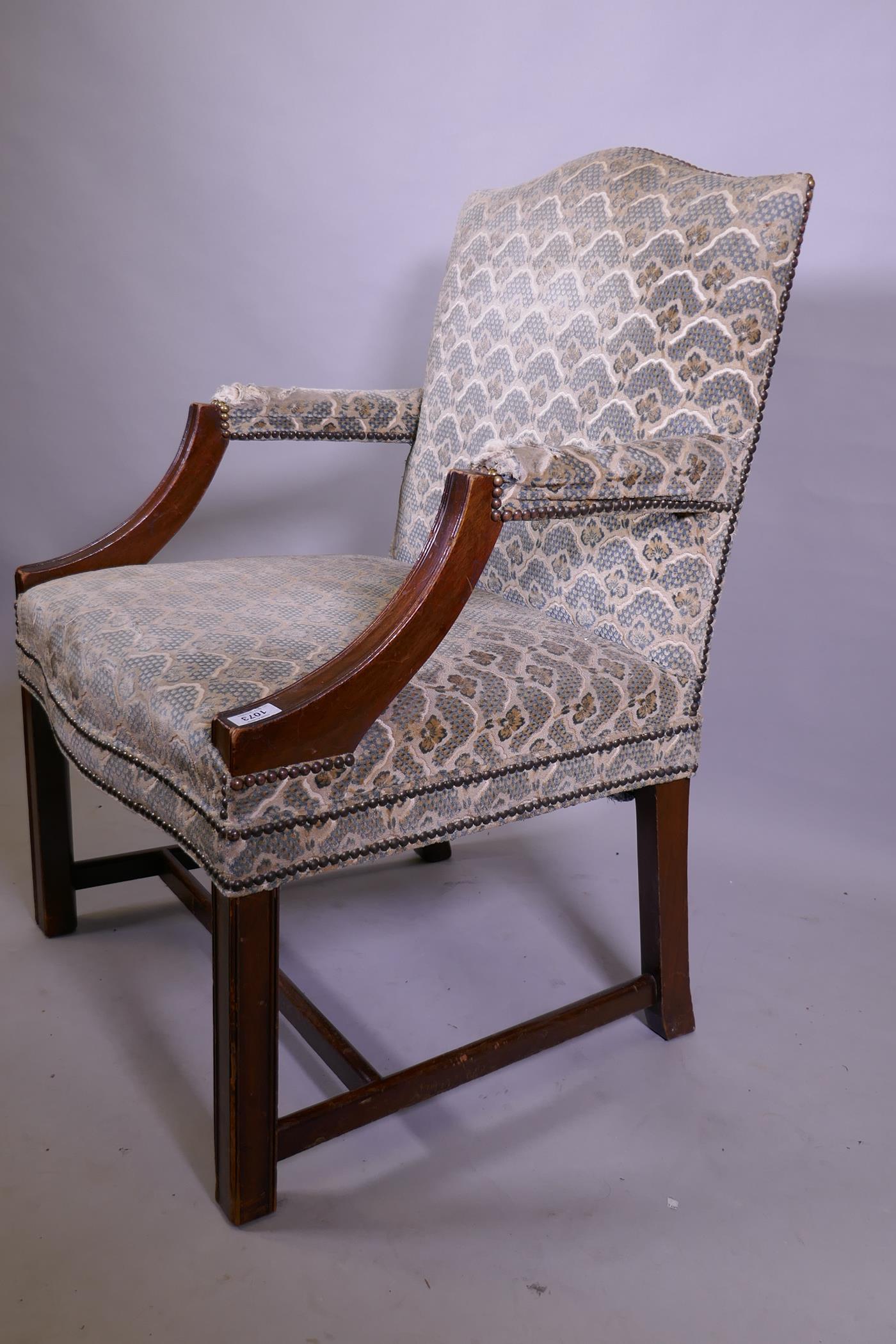 A Georgian style hump back mahogany framed open arm chair, raised on moulded supports united by an H - Image 2 of 2