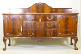 A mahogany Chippendale style serpentine front sideboard, with carved decoration and canted