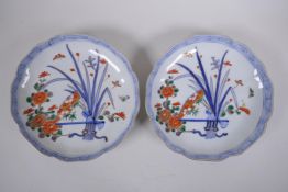 A pair of oriental porcelain shaped rim dishes with floral decoration, in an Imari palette, marks to