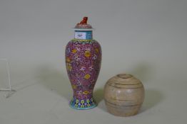 A Chinese ceramic jar and cover with enamel decoration, seal mark to base, 28cm high, and a
