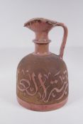 A terracotta ewer with raised Islamic script decoration, possibly Hispano Moresque, 32cm high