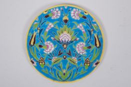 A French Iznik style faience plate with enamelled floral decoration, 21cm diameter