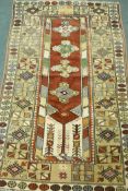 A Persian full pile multicolour ground wool carpet, the central panel with floral medallions on a