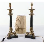 A pair of French gilt and patinated metal candlestick table lamps in Louis Philippe taste