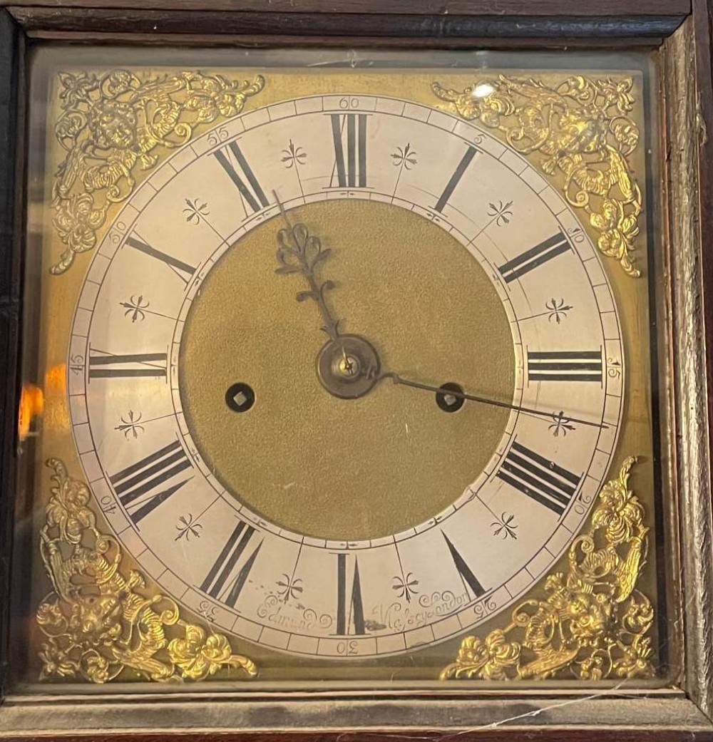 A rare early 18th century four pillar longcase clock, brass and silvered dial signed Edmund M