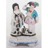 An 18th century porcelain group of man and woman with two dogs