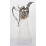 An Art Nouveau style silver and glass claret jug