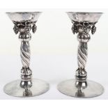 A pair of Georg Jensen silver grape pattern candlesticks