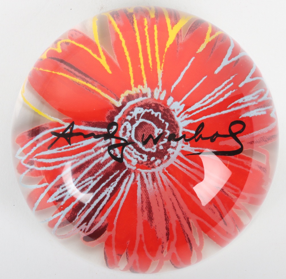 An Andy Warhol glass paperweight