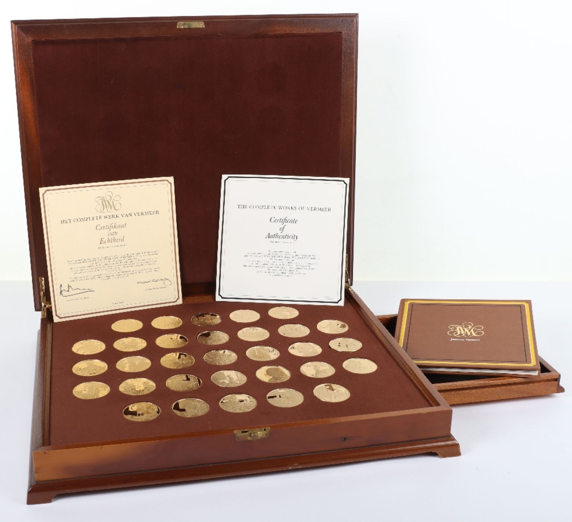 A set of 1970’s silver gilt medallions ‘The Complete Works of Vermeer’, in fitted case with papers,