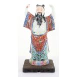 An early 20th century enamel and ceramic Chinese figure of an elder
