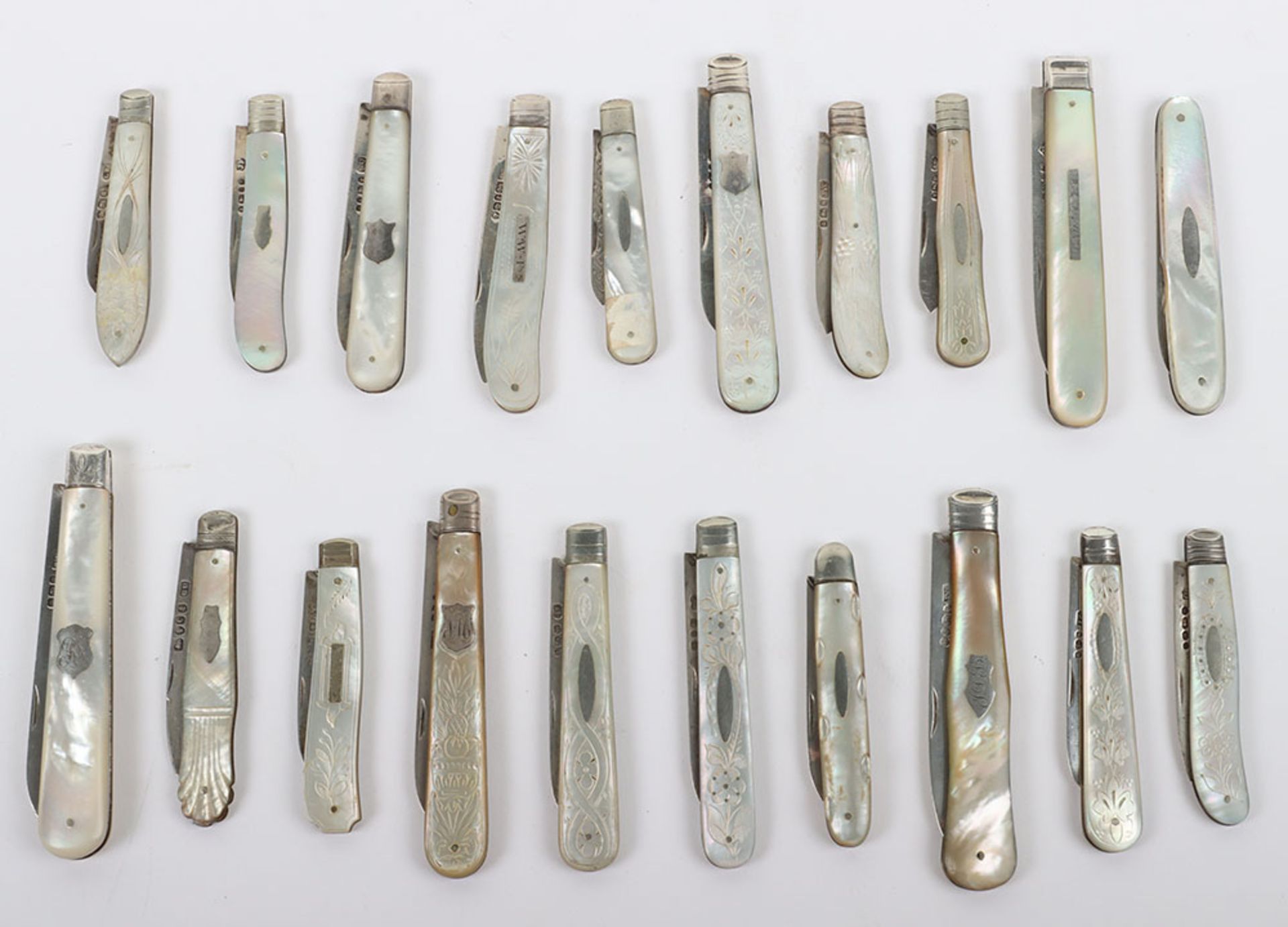 Twenty Victorian silver and mother of pearl folding fruit knives