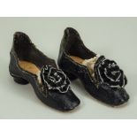 Pair of black leatherette Fashion style doll shoes,