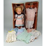 A hard composition baby doll with wardrobe, English 1950s,