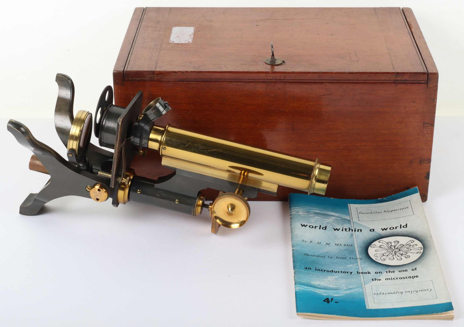 A late Victorian brass microscope and lens, W. Johnson & Sons London