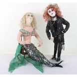 Two character dolls by Rosemary Bradshaw of a punk rock ‘chick’ and a mermaid seated in wood chair